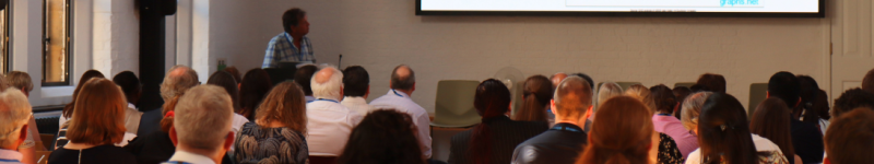 A presenter stands before an audience at the IFST Oxford Food Summit 2025: Designing adaptive food systems for sustainable nutrition